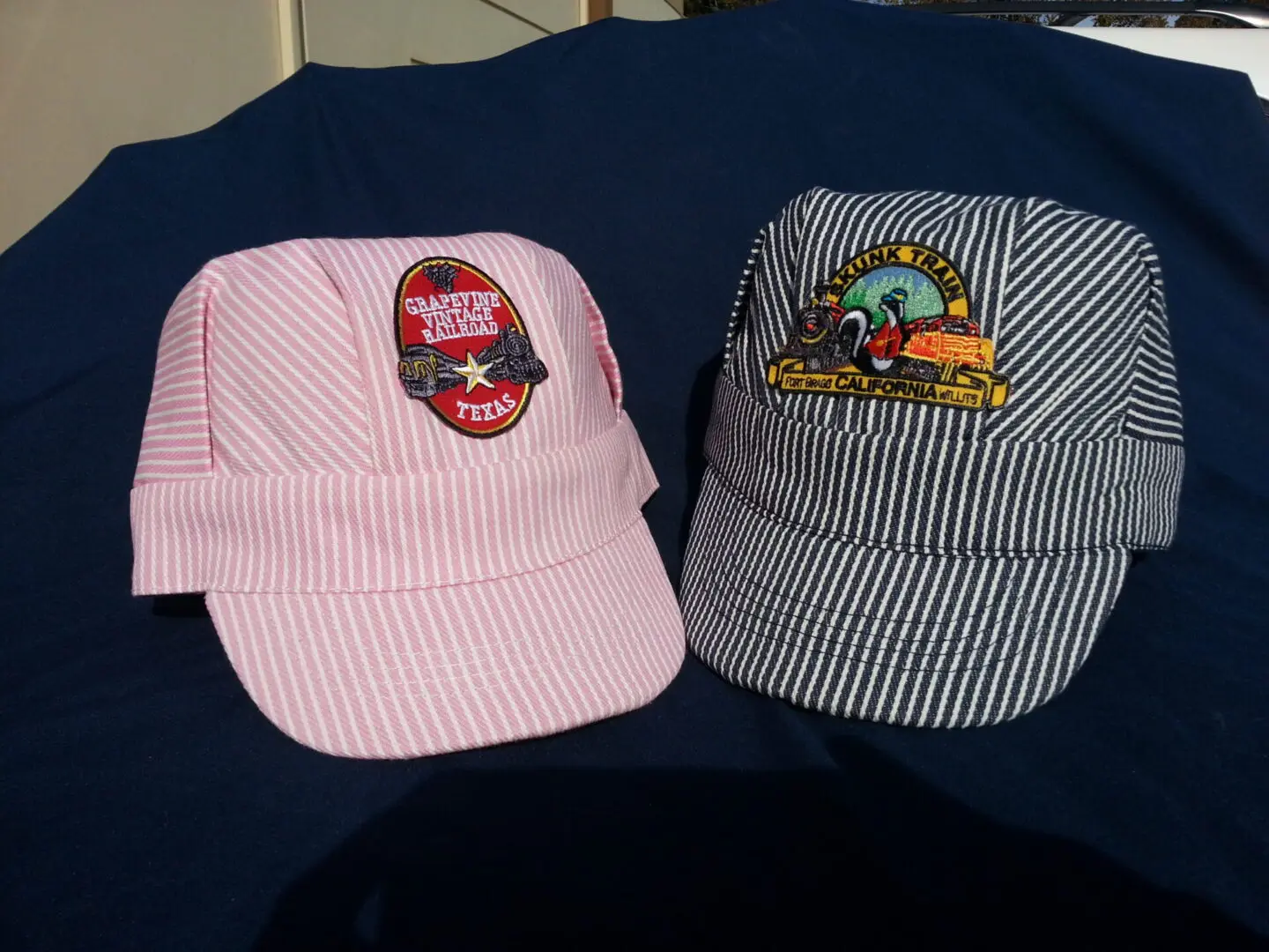 pink and black color hats on display